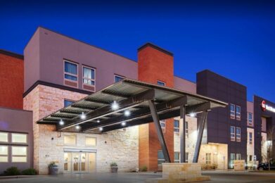 the front entrance to a hotel at night